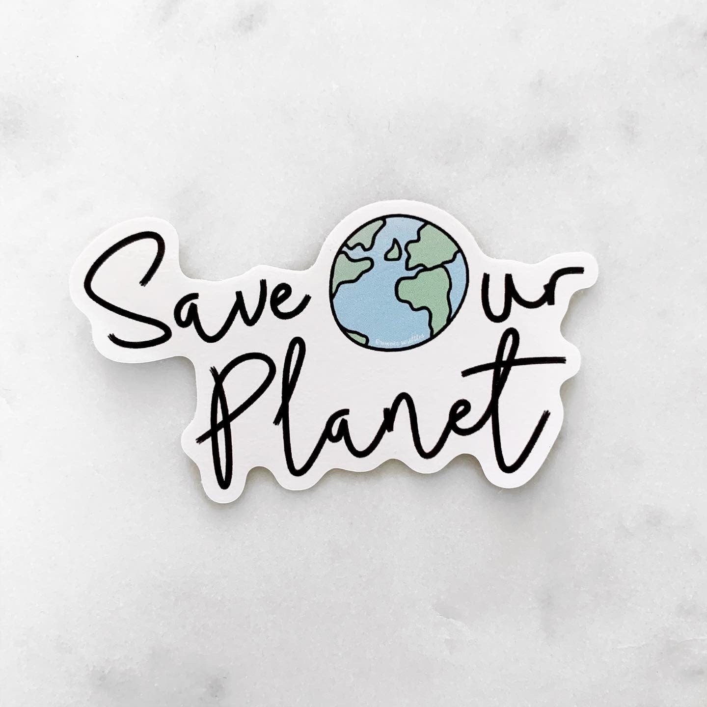 Sticker with 'Save Our Planet' text and Earth illustration on a marble background