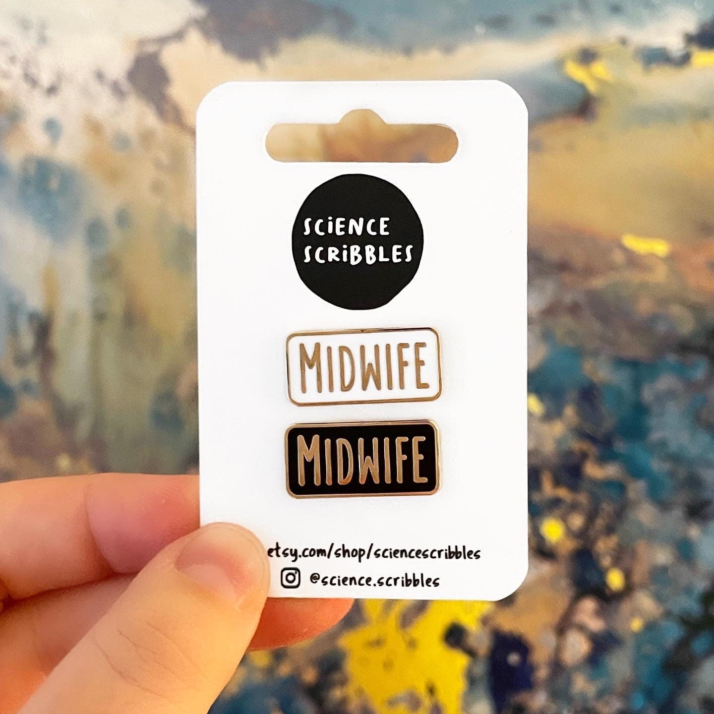 Card with 'Science Scribbles' branding and 'Midwife' text held against a blurred natural background