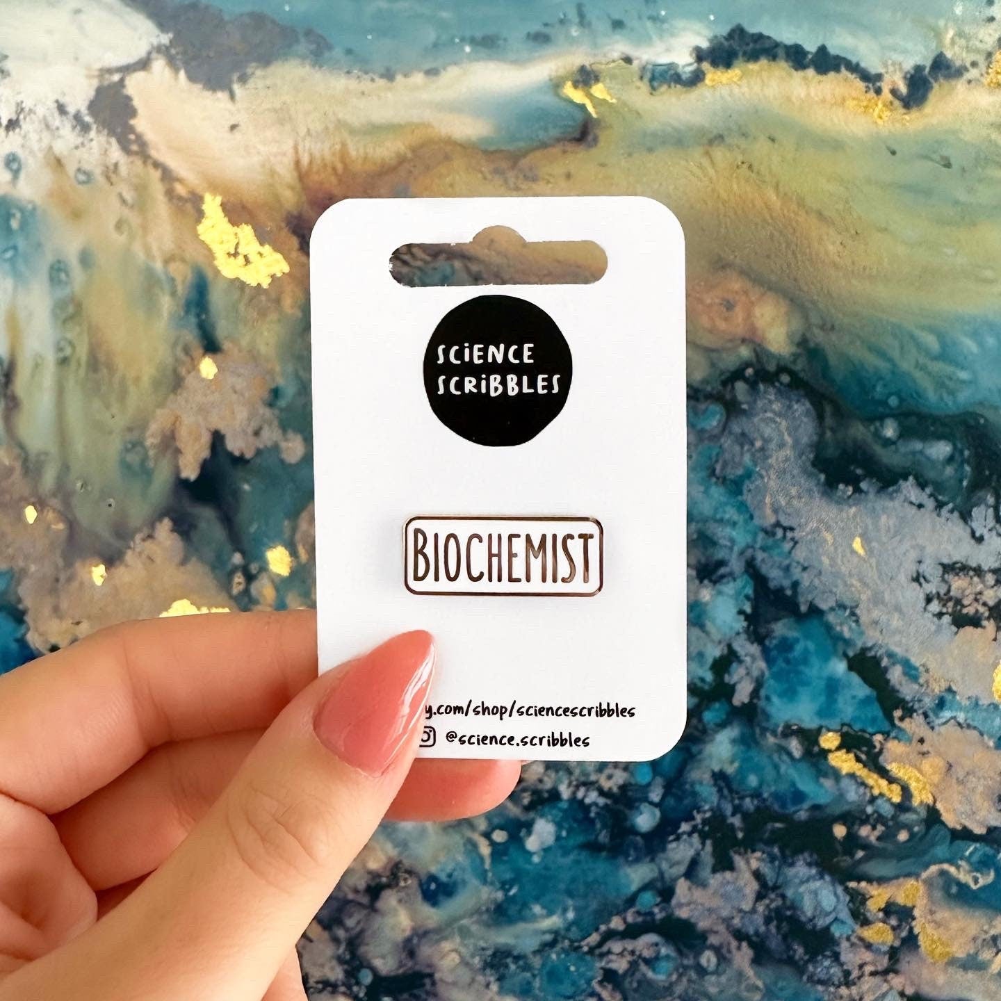 Card labeled 'Biochemist' held by a hand against a colorful abstract background