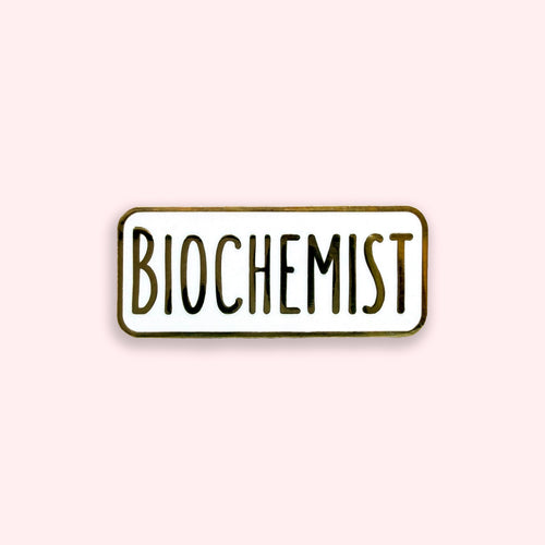Enamel pin with 'BIOCHEMIST' text on a light pink background