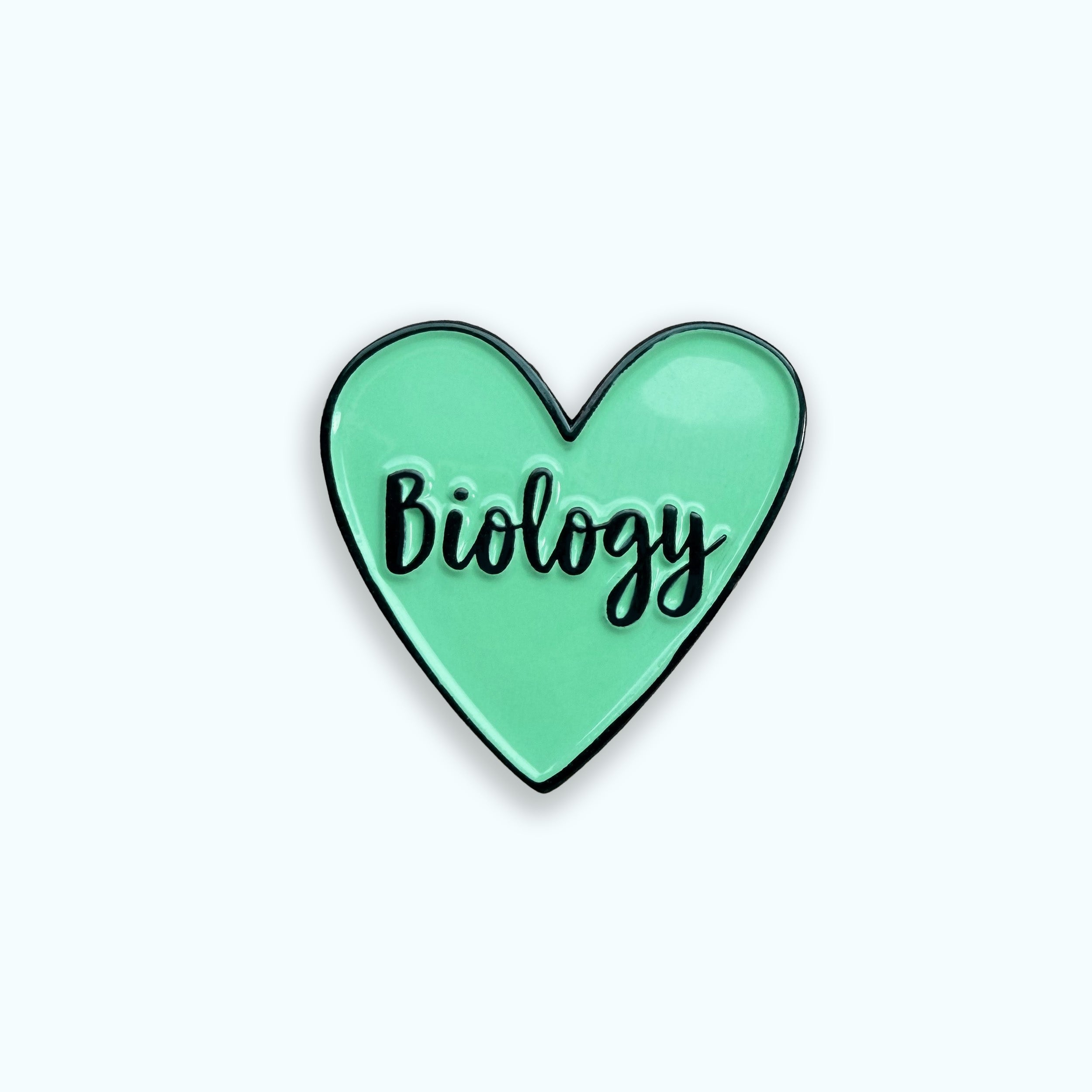 Heart-shaped pin with 'Biology' text on a blue background