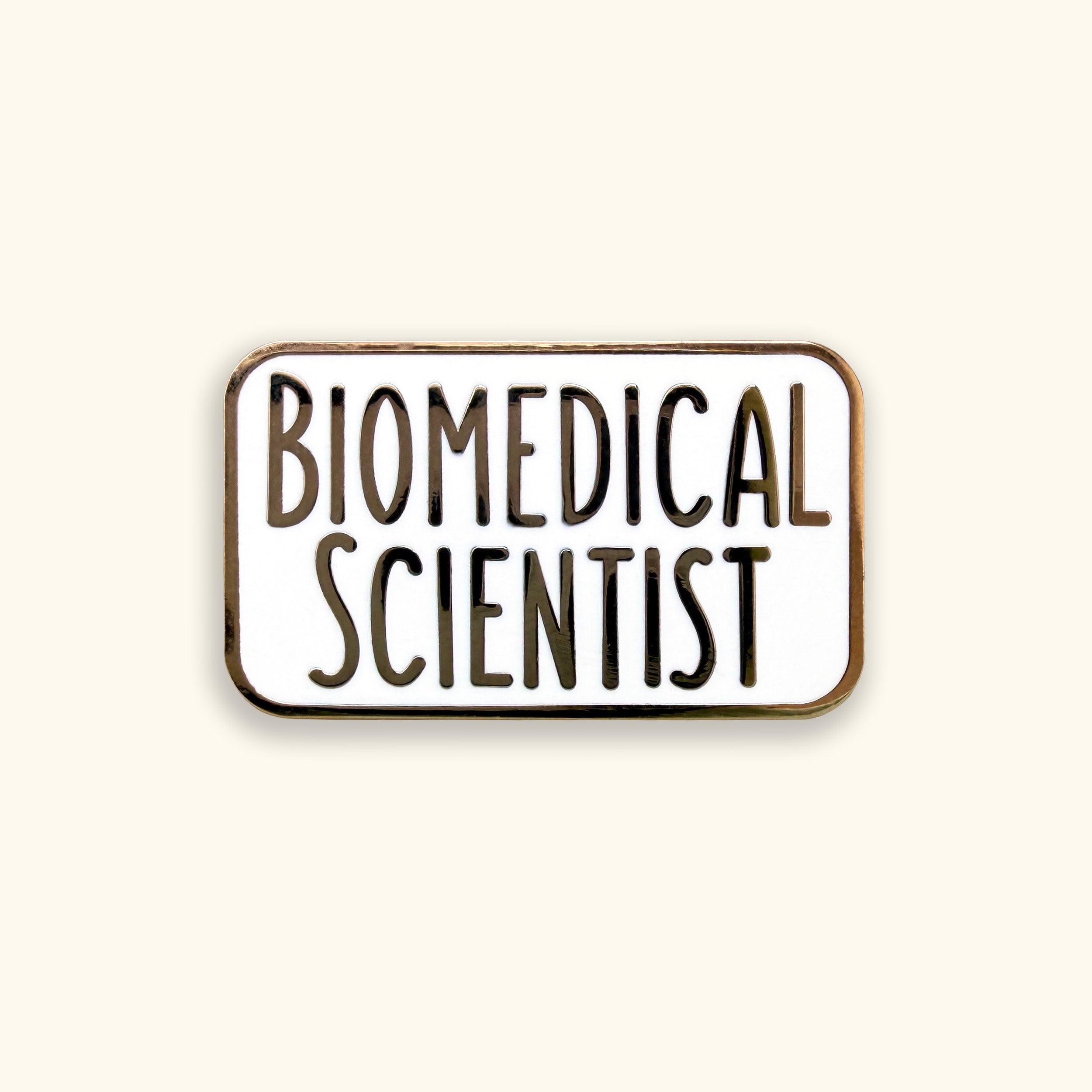 Enamel pin with 'BIOMEDICAL SCIENTIST' text on a yellow background