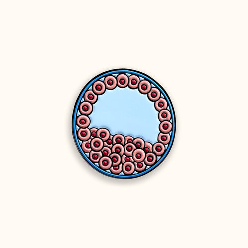 Blastocyst pink and blue enamel pin badge on yellow background