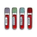 Four test tubes labeled EDTA, Heparin, Citrate, and Serum on a white background.