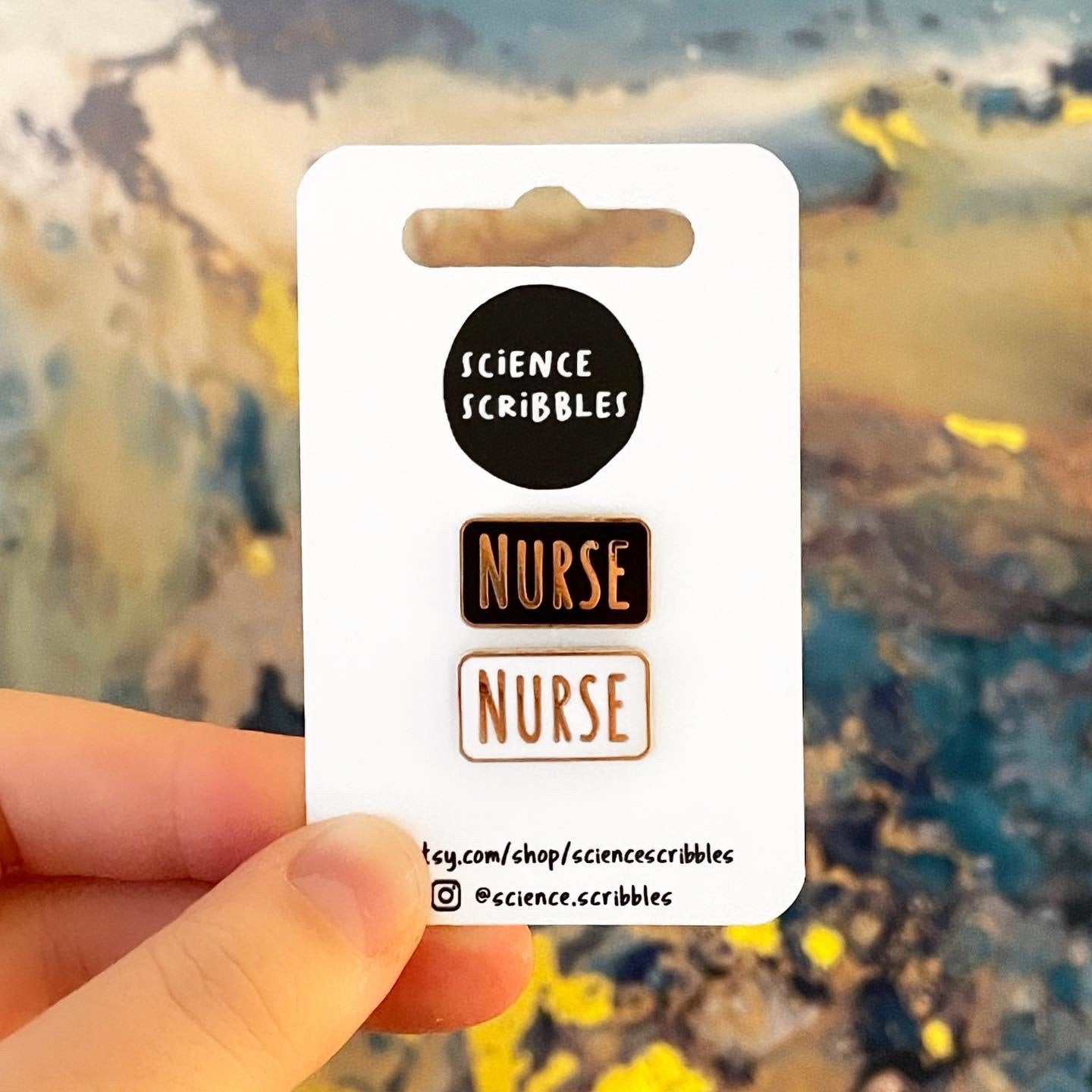 Card with 'Science Scribbles' and 'Nurse' text held against a blurred natural background
