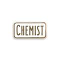Enamel pin with 'CHEMIST' text on a white background