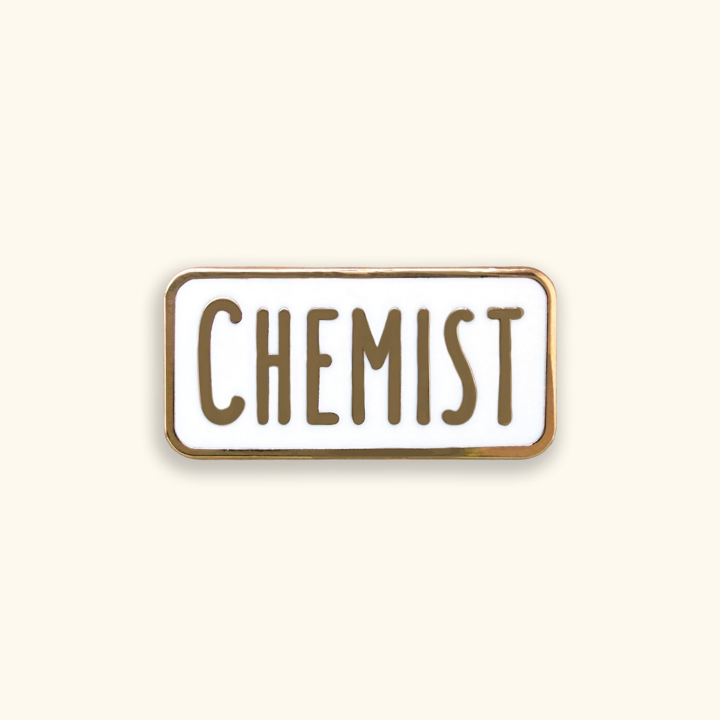 Enamel pin with 'CHEMIST' text on a yellow background