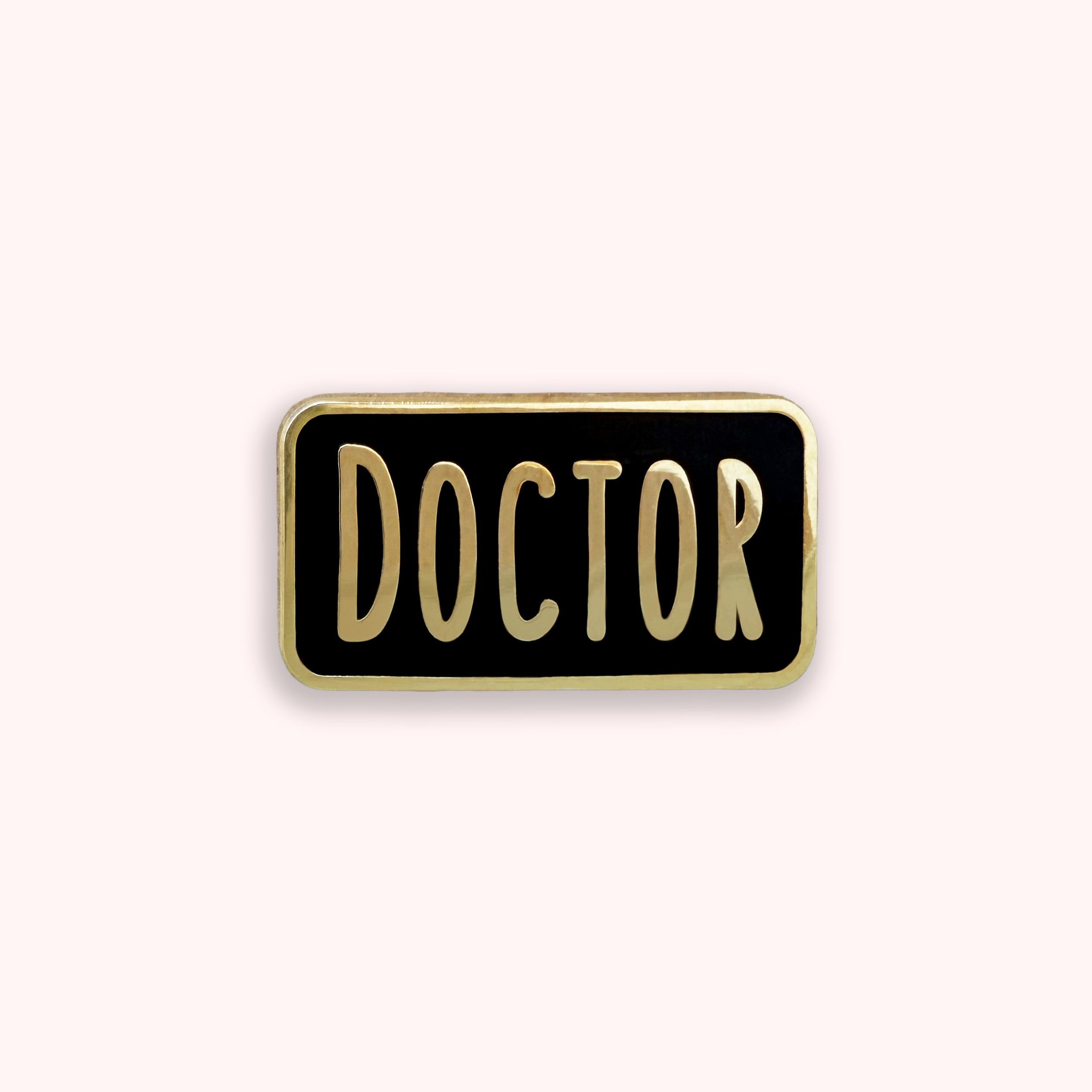 Pin with 'DOCTOR' text on a black background