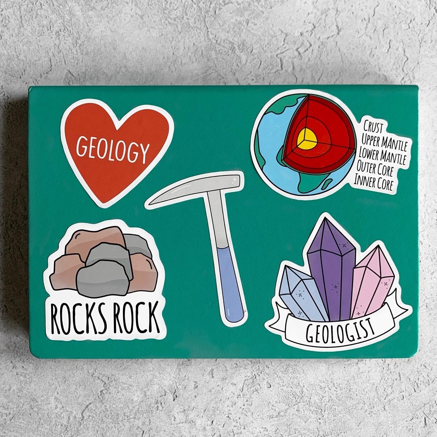 Geology-themed stickers on a teal background