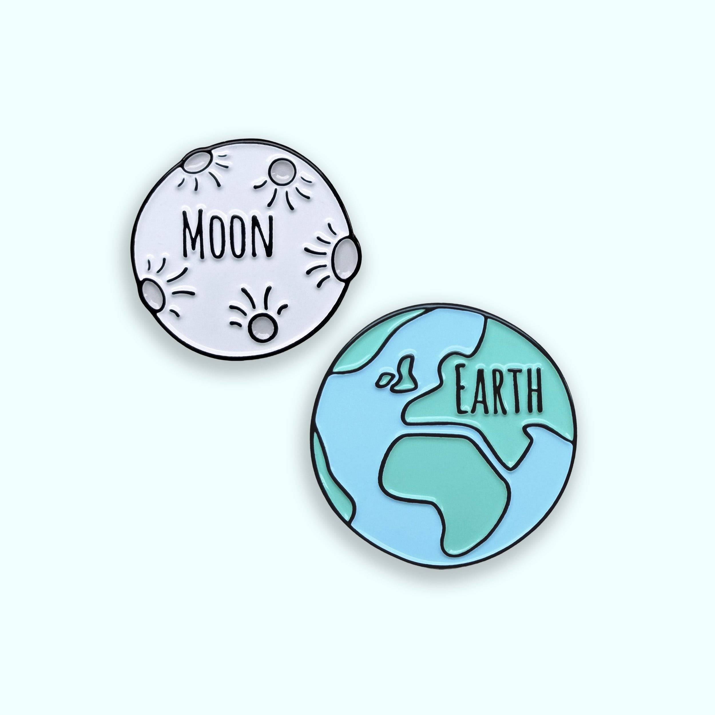 Earth and Moon enamel pin set on green background