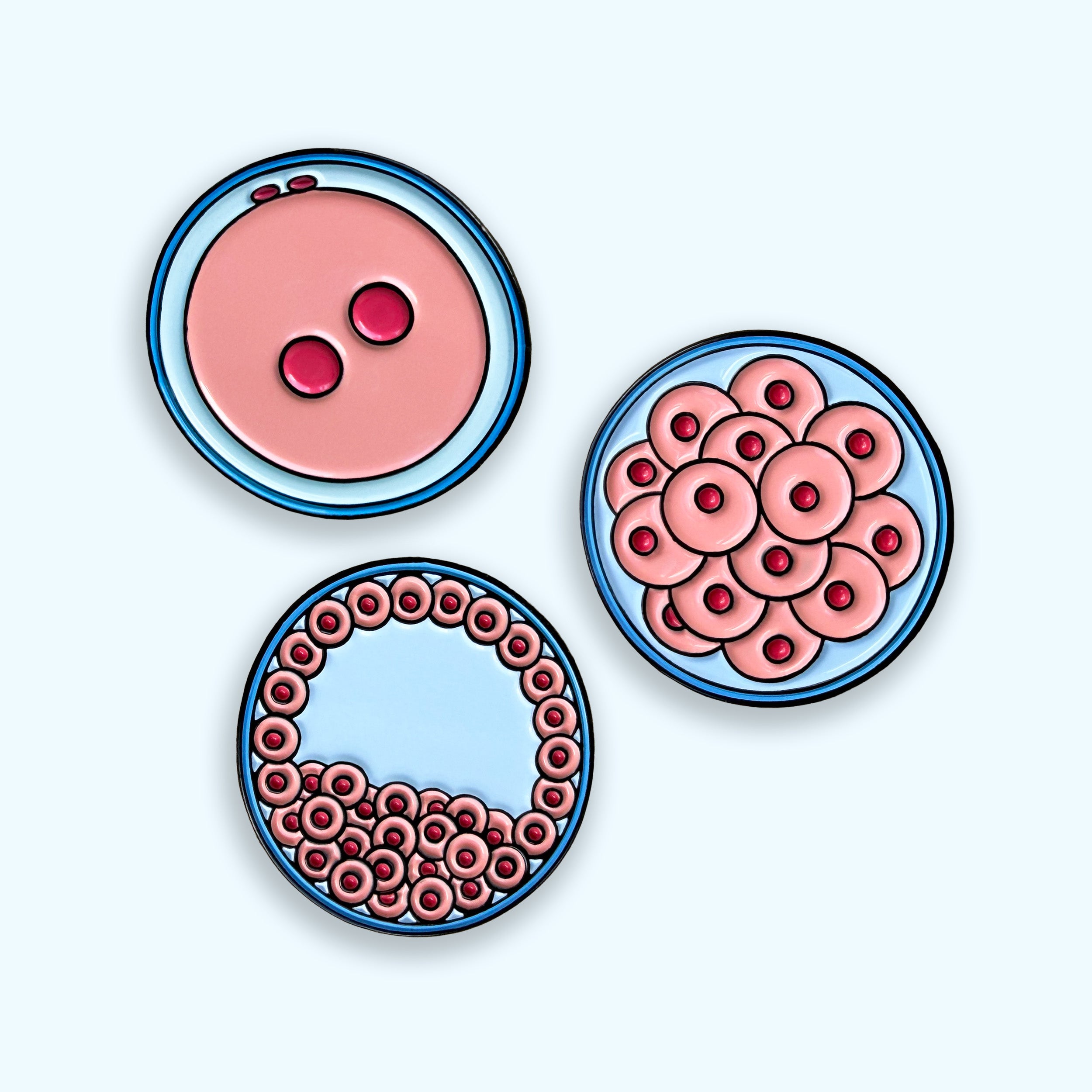 Embryo development enamel pin set featuring zygote morula and blastocyst on blue background