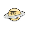Saturn yellow enamel pin badge on white background