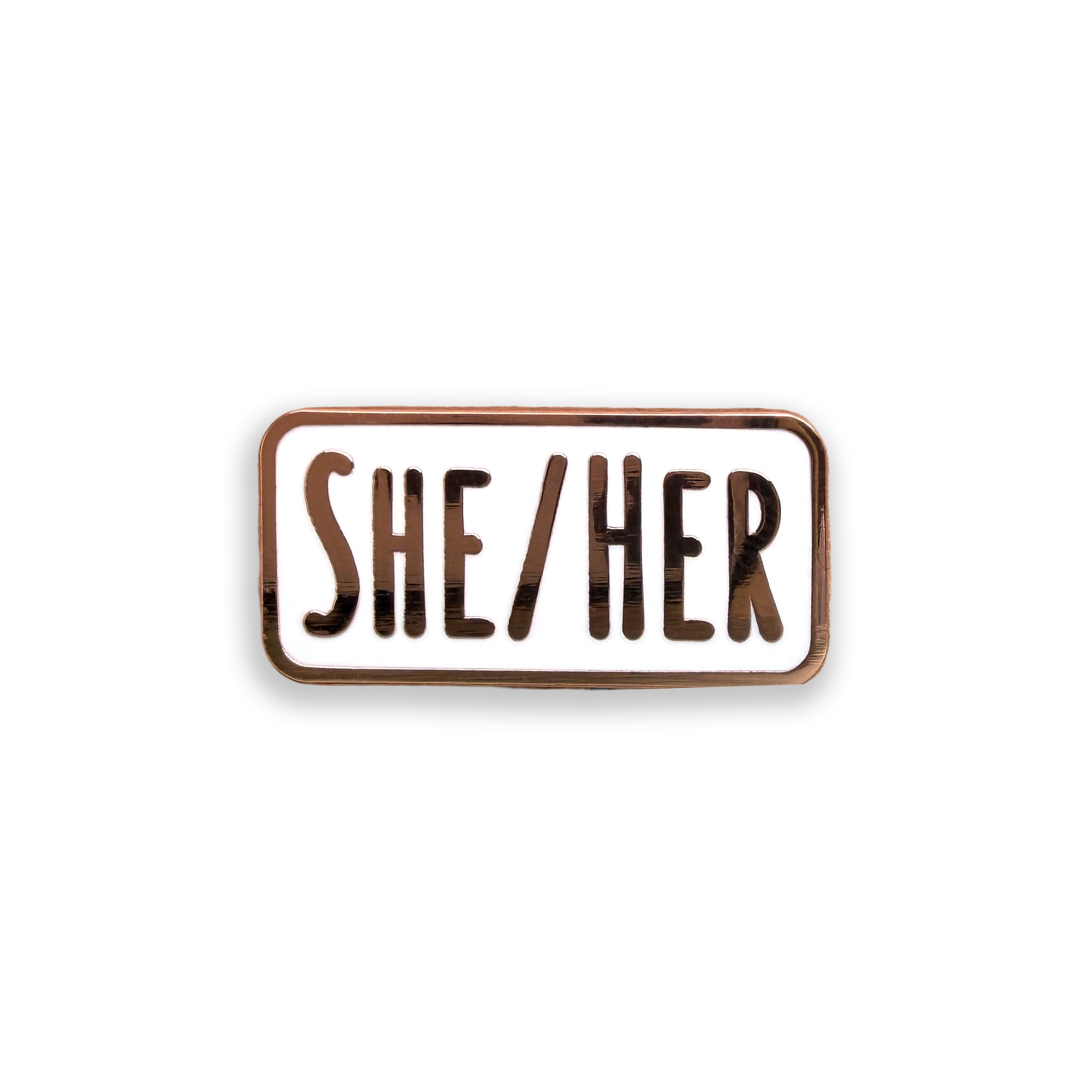 Enamel pin with 'SHE/HER' text on a white background