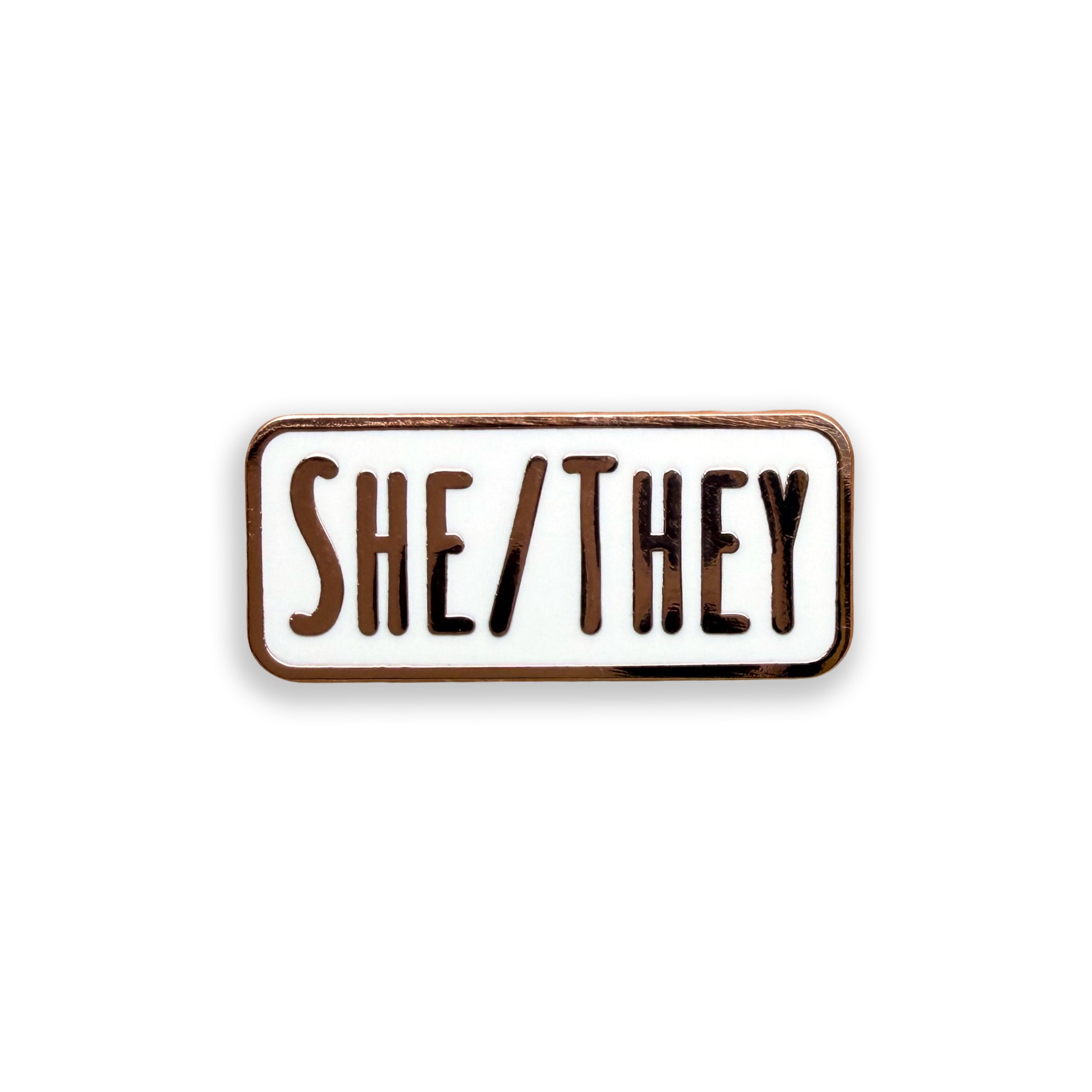She/They pronoun white and rode gold enamel pin badge on white background