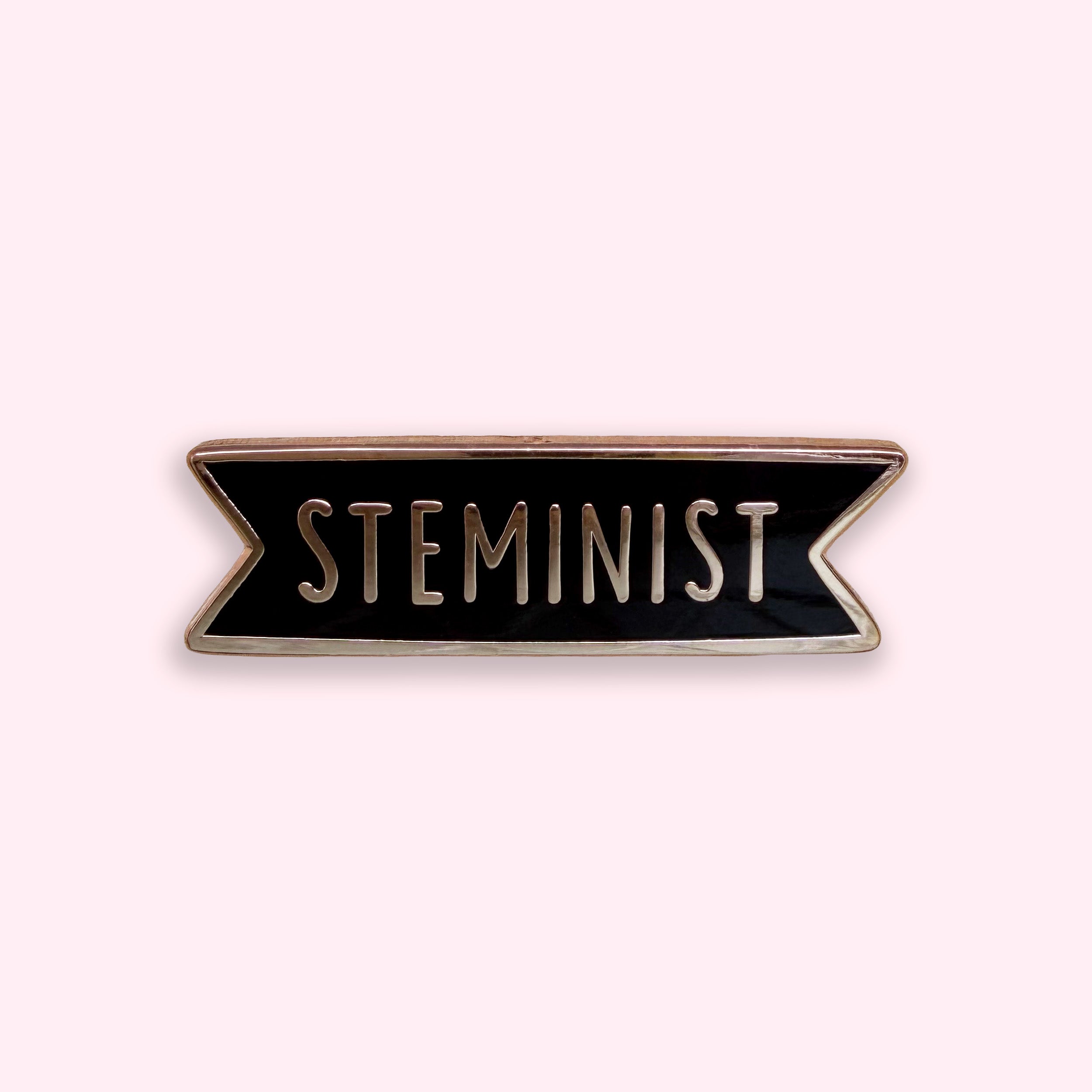 Steminist enamel pin badge with rose gold plating on pink background