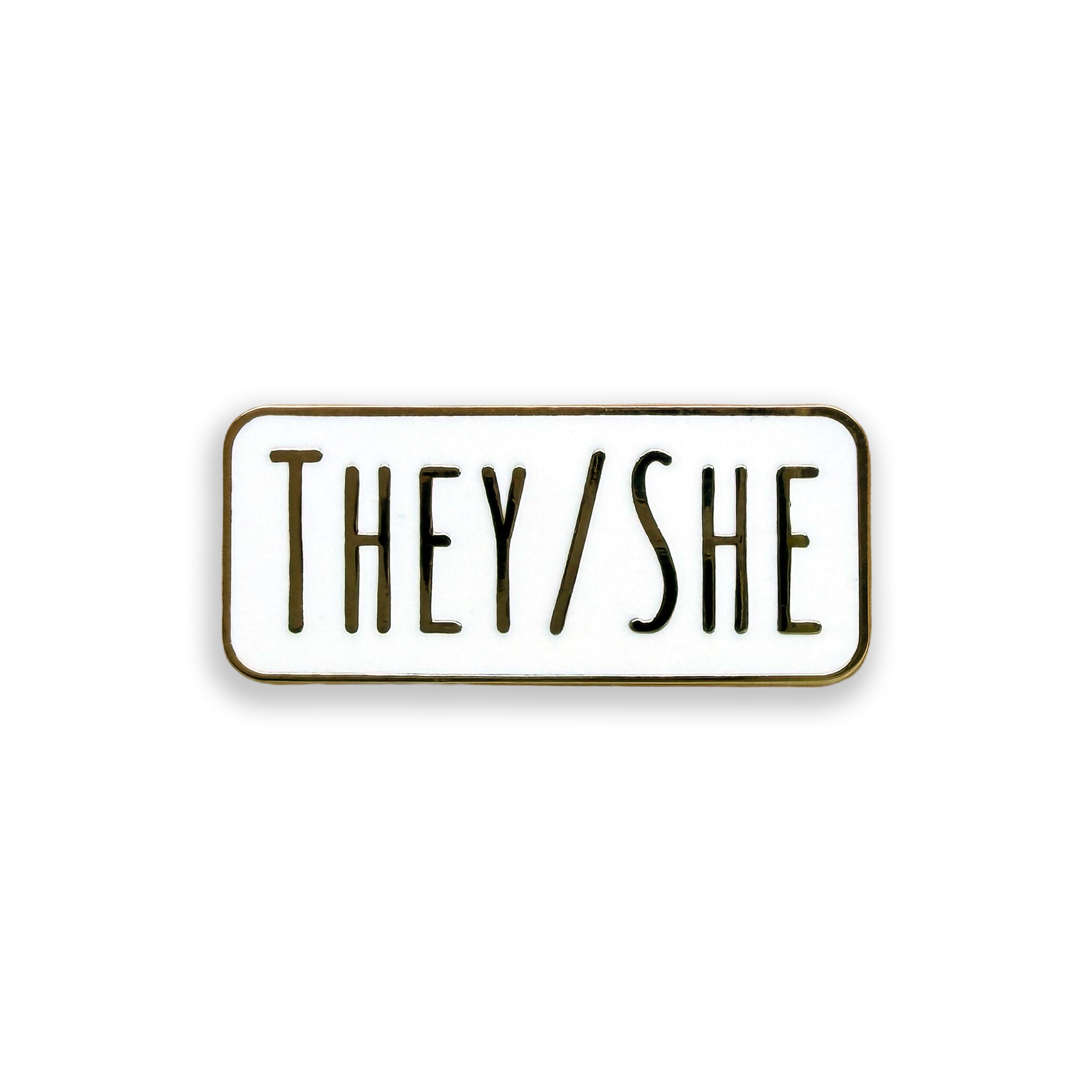 Enamel pin with 'THEY/SHE' text on a white background